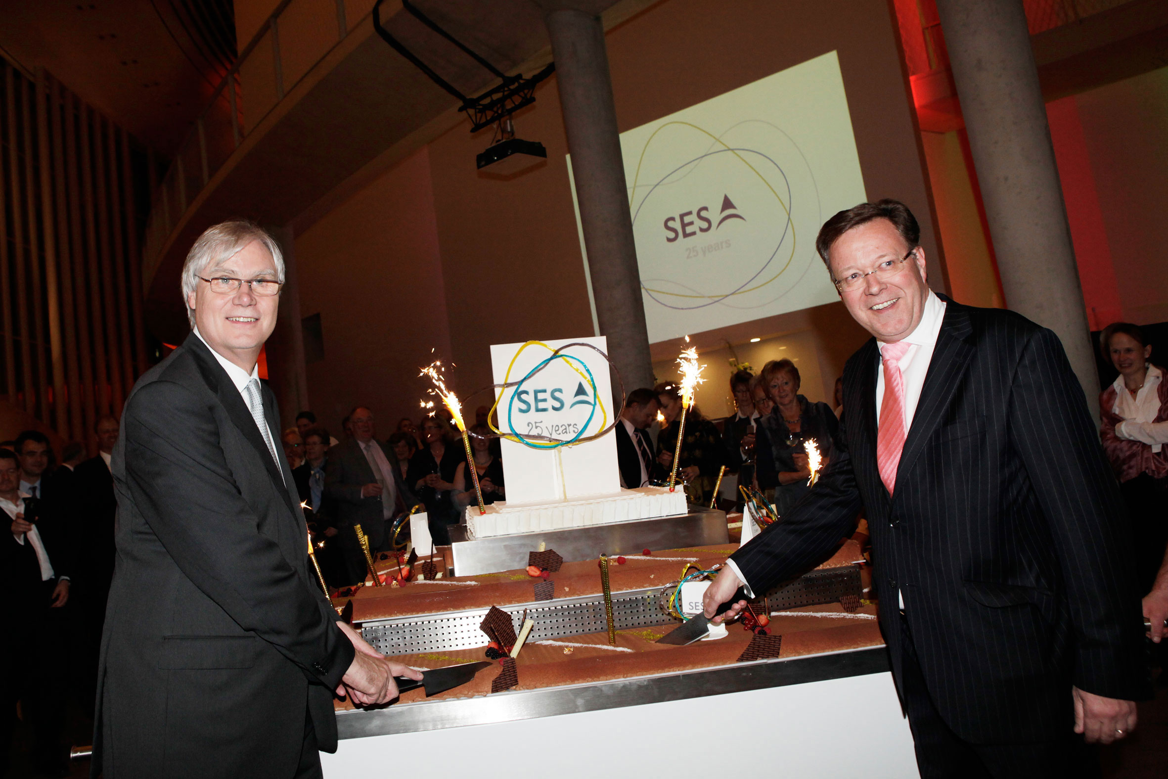Cake being cut on SES 25th anniversary