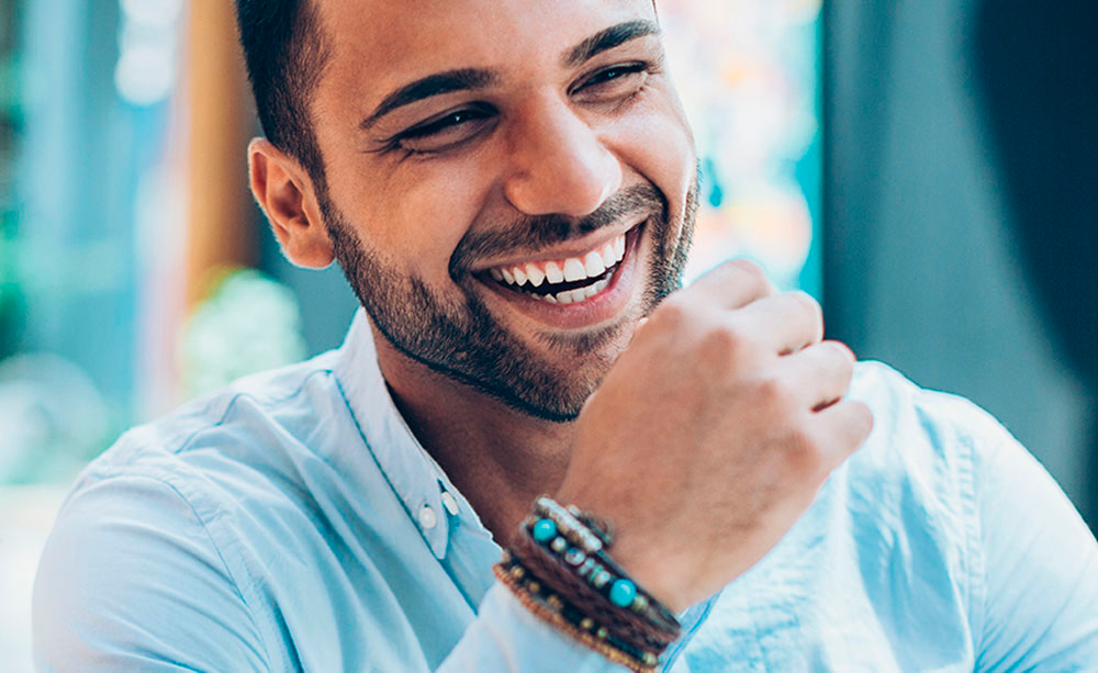 smiling man on a laptop