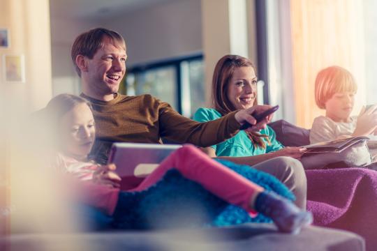 parents with children watching tv