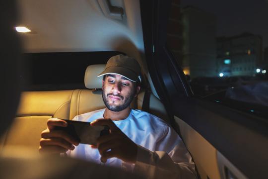 Man watching video on phone in car