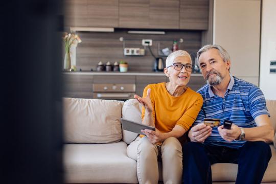 Couple watching shopping channel on tv