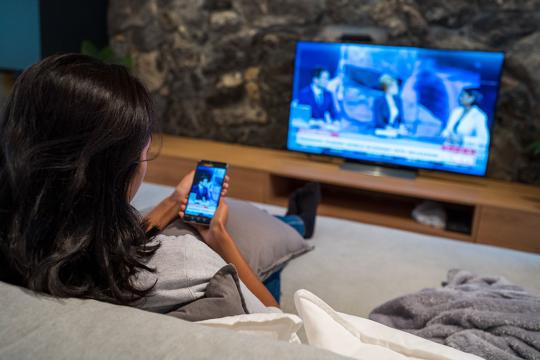 woman watching news on tv