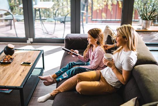 mother and daughter watching tv