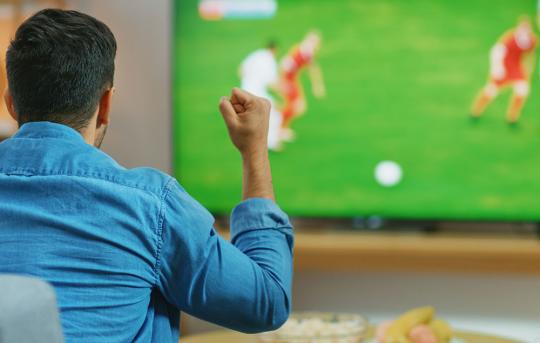 Man watching football game on tv