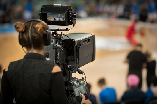 Camera woman shooting basketball game