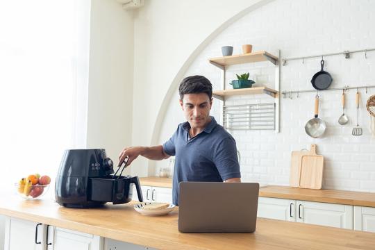 Man watching on-demand cooking programme