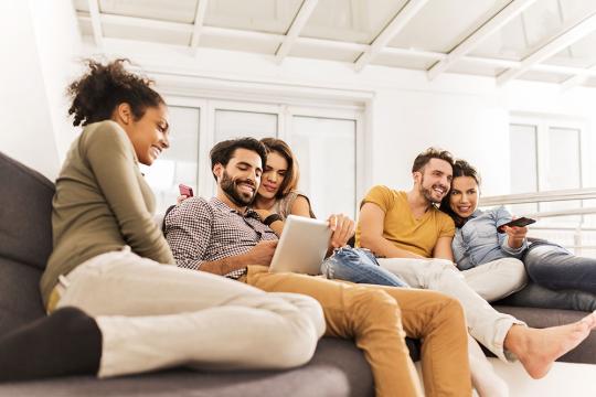 Friends watching tv and tablet