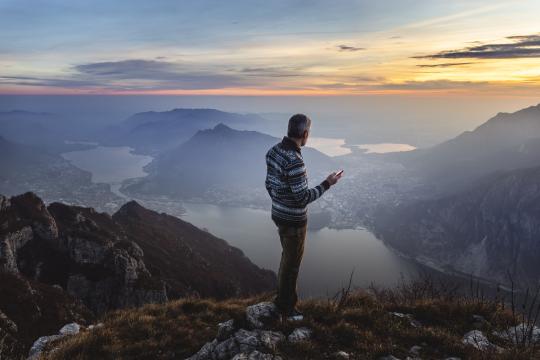 Man hiker solo on the mountain during golden hour