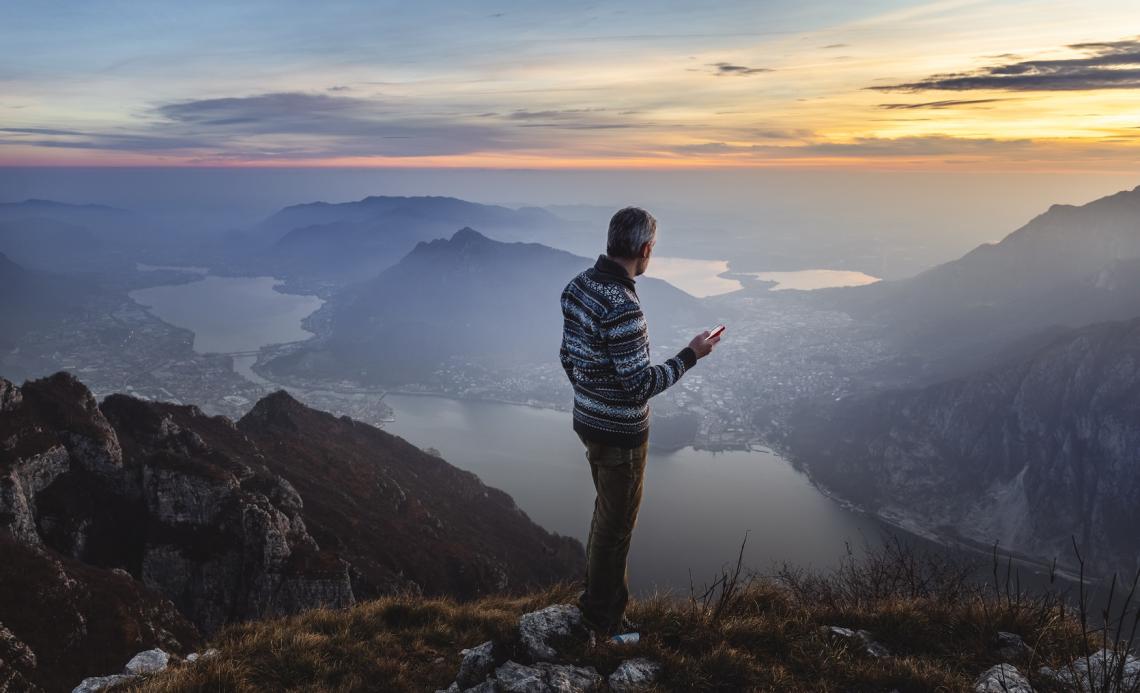 Man hiker solo on the mountain during golden hour