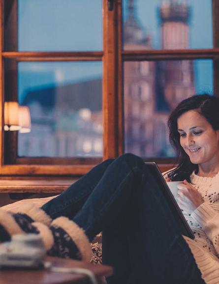 woman on sofa watching video on tablet