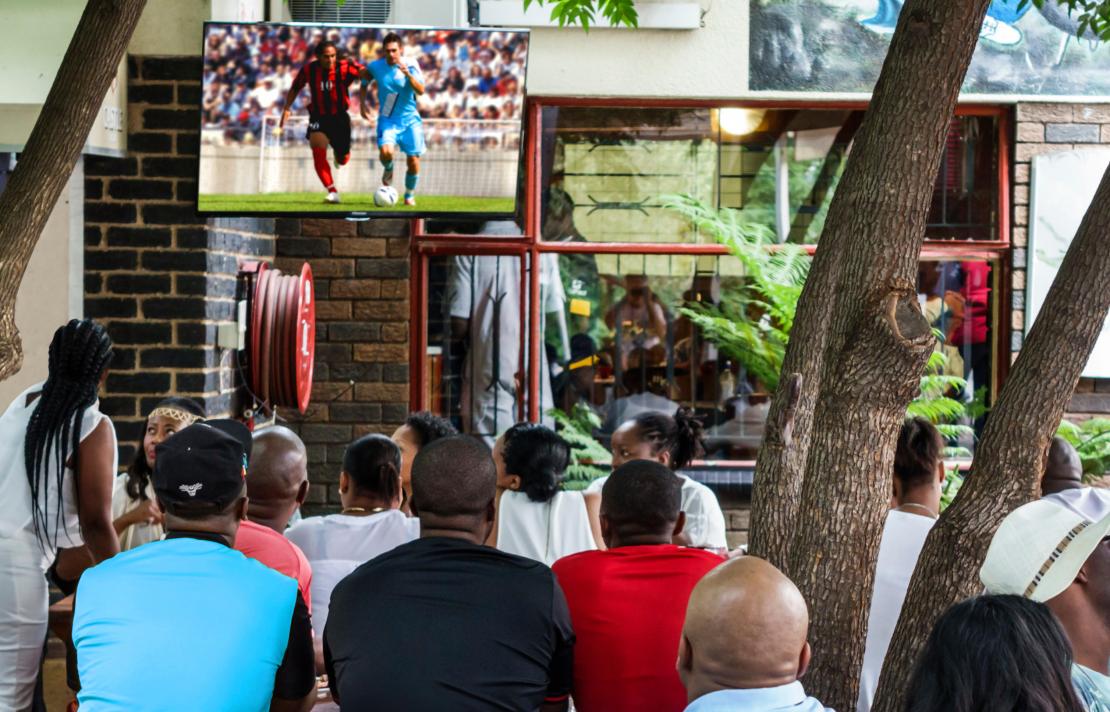 image of people watching football on tv