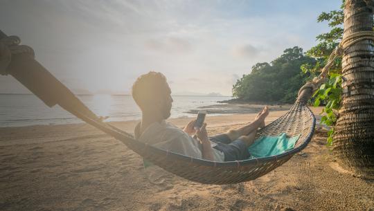Man on beach with mobile banner image