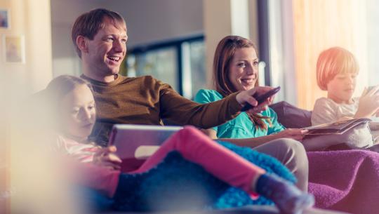 parents with children watching tv