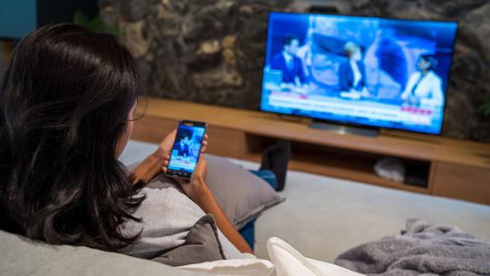 woman watching news on tv