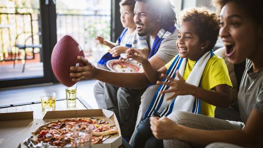 Family watching football on tv