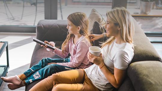 mother and daughter watching tv