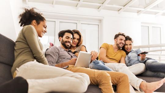 Friends watching tv and tablet