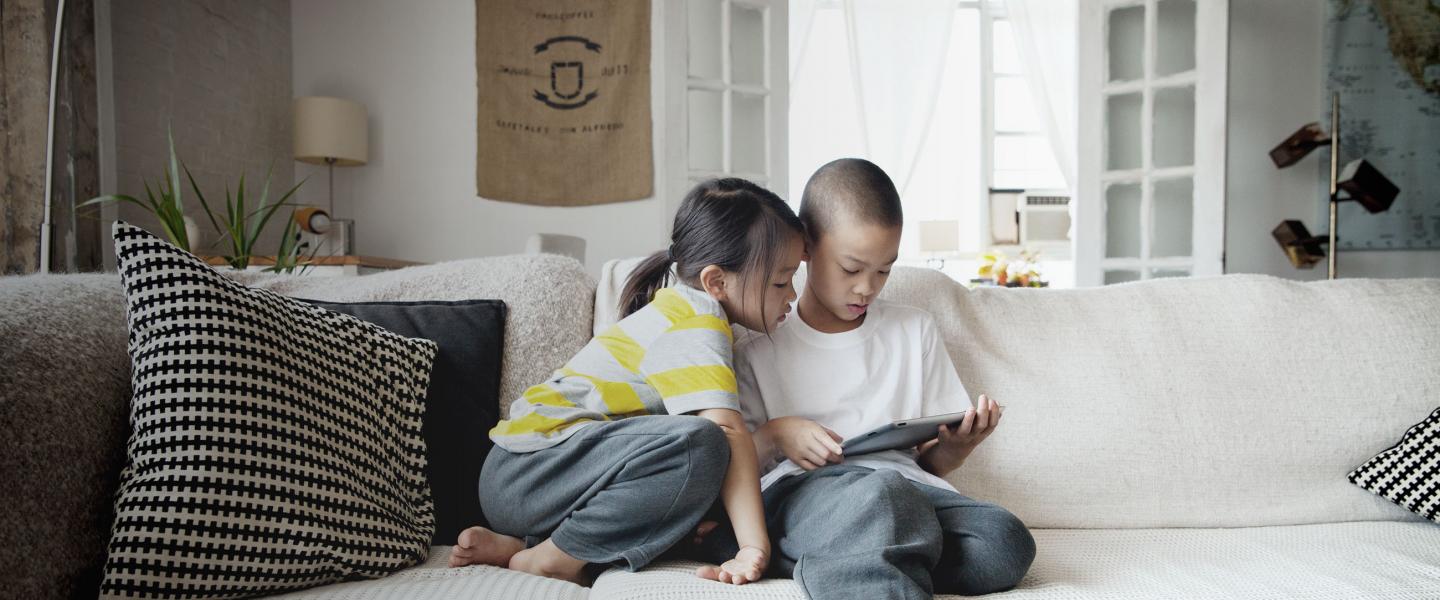 Children on couch with tablet