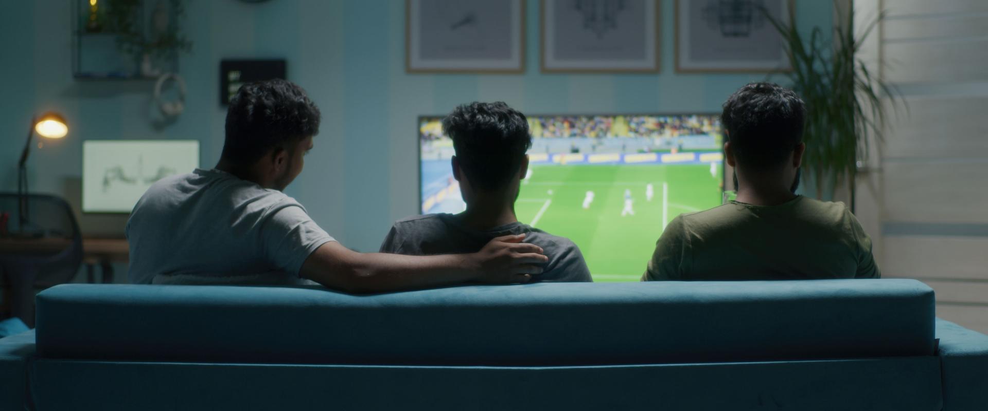 Men watching football match on tv