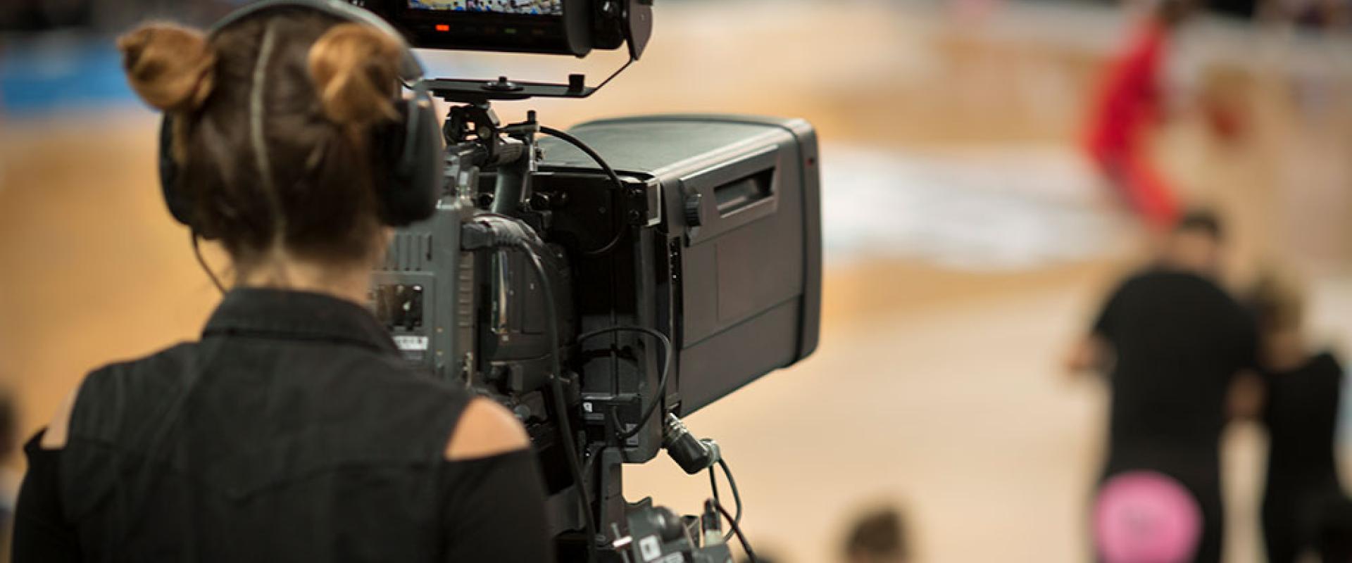 Camera woman shooting basketball game