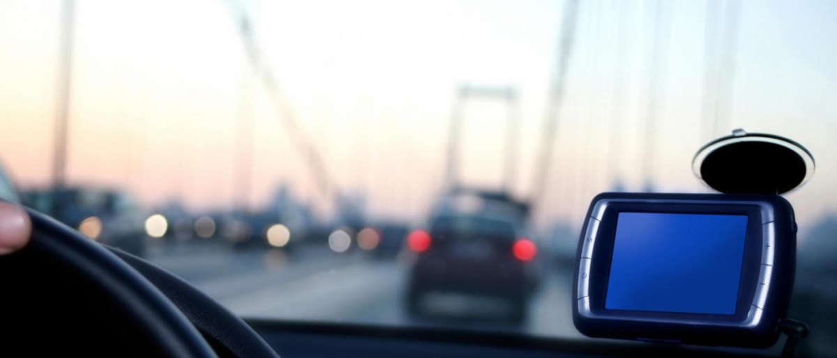 Image of car dashboard view on a bridge at dusk.