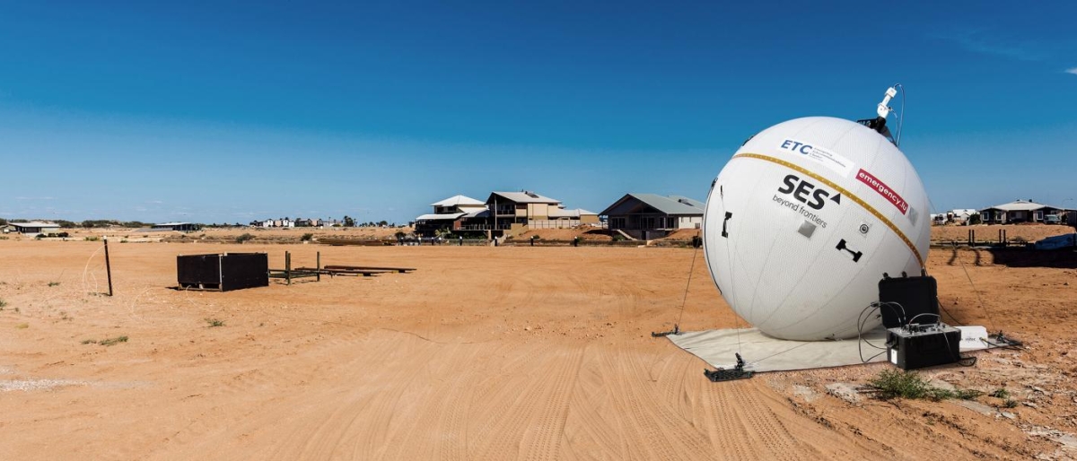 Image of SES emergency communications balloon deployed on a sandy field.