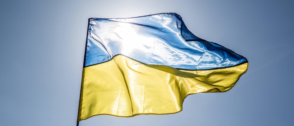 Image of Ukrainian flag waving in the sunlight.