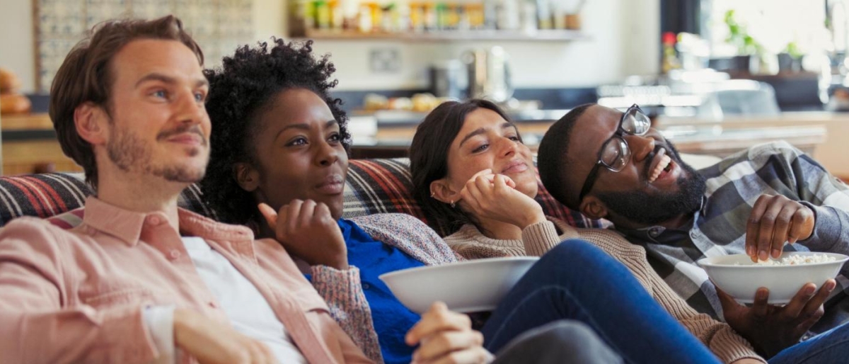 Image of a group of friends having fun watching TV.