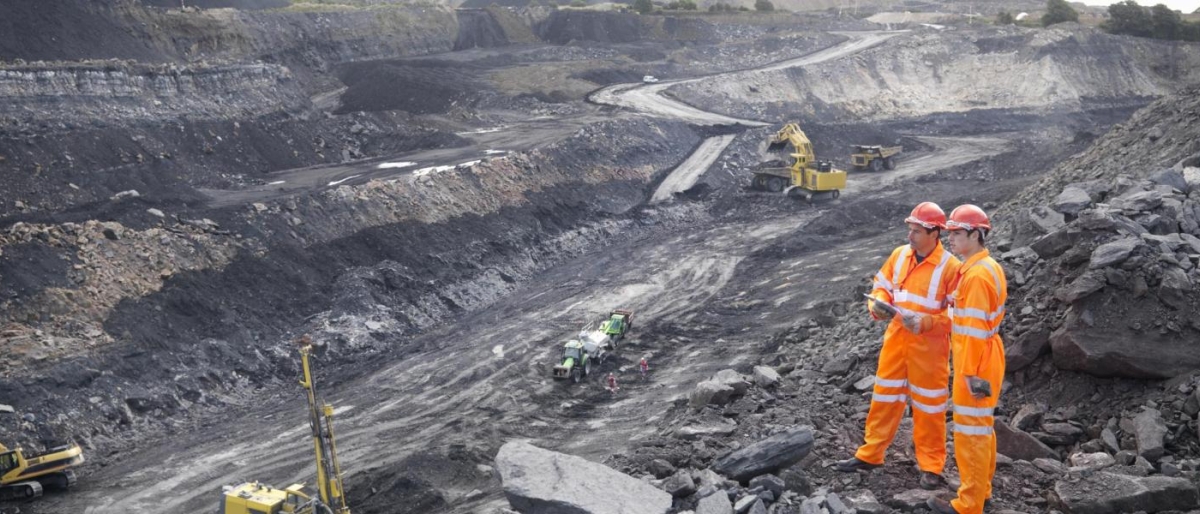 Image of two workers in a mining field.