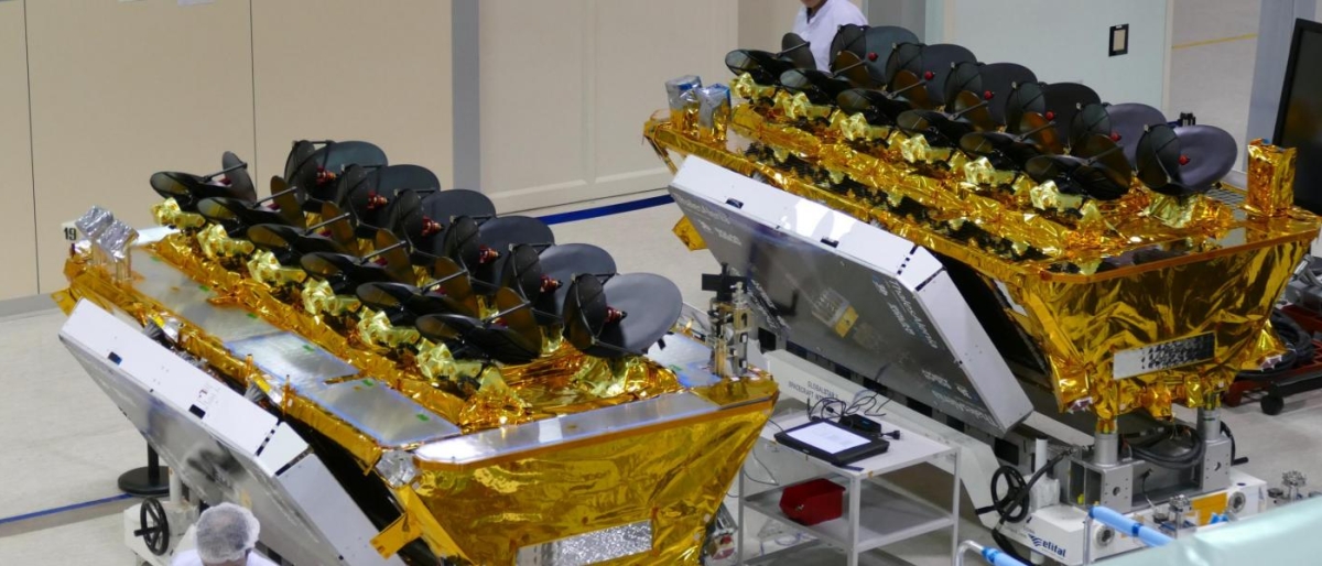 Image of two O3b satellites in a cleanroom with gold insulation.