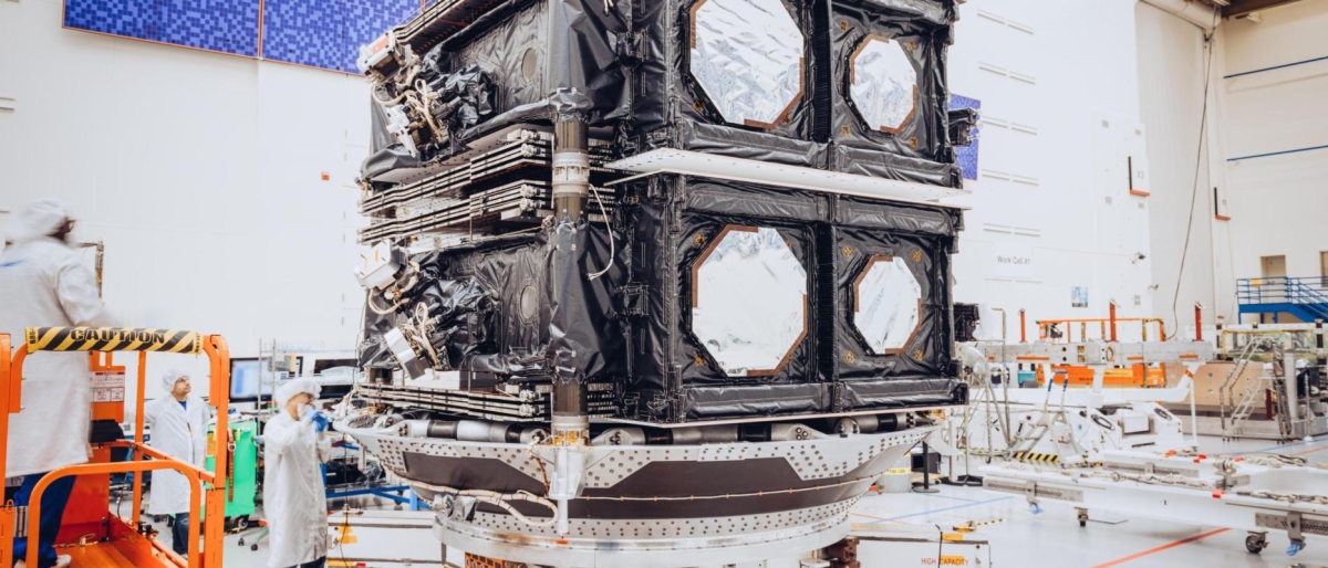 Image of two O3b mPOWER satellites stacked in a cleanroom