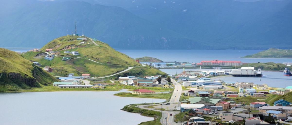 Image of a coastal town surrounded by hills and water.