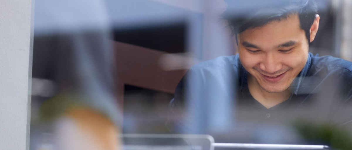 Image of a person happily using a device.