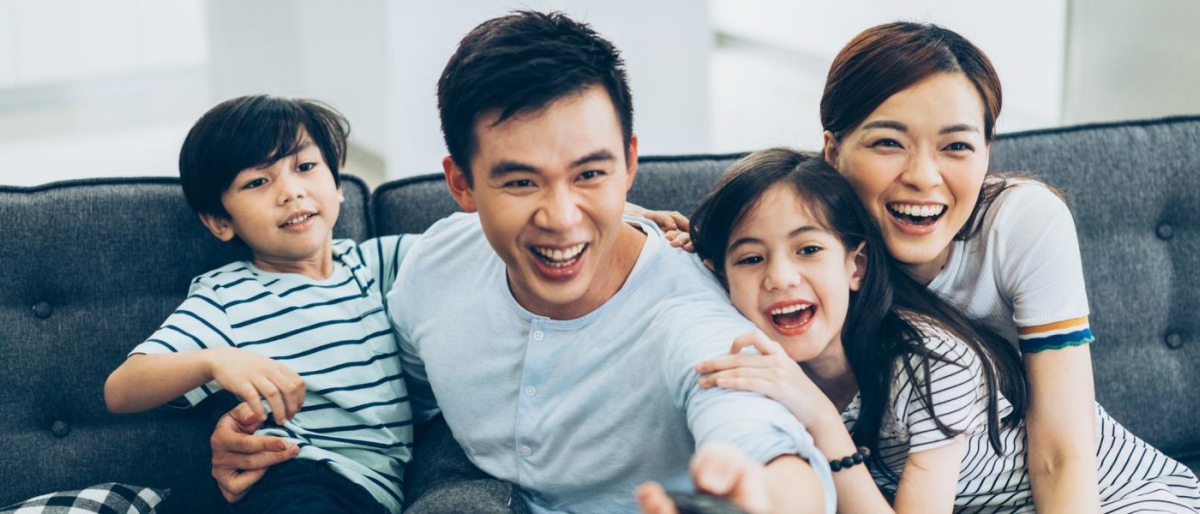 Image of a family on the couch enjoying television.