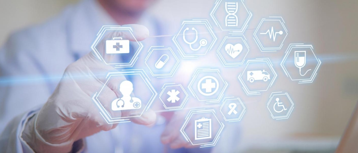 Image of a medical professional interacting with glowing digital health icons.