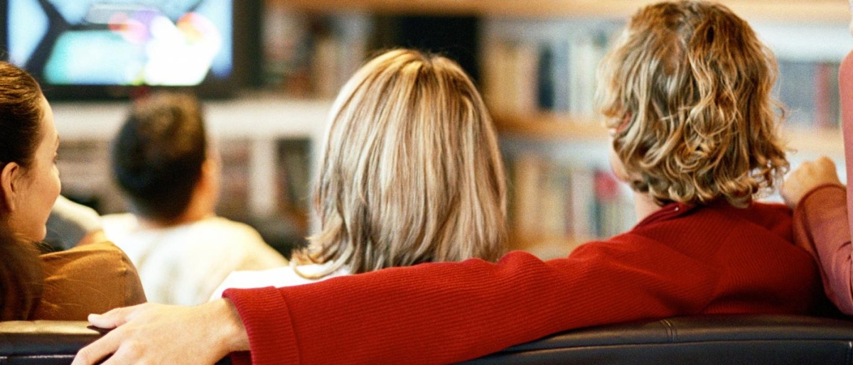 Image of people sitting together watching television.
