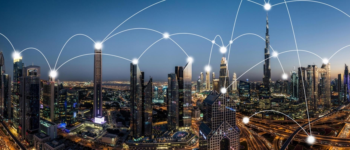 Image of city skyline at dusk with glowing network lines connecting across skyscrapers.