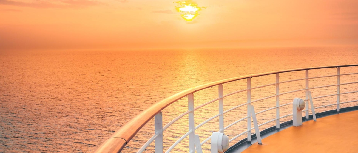 Image of an orange sunset from a ship's deck.