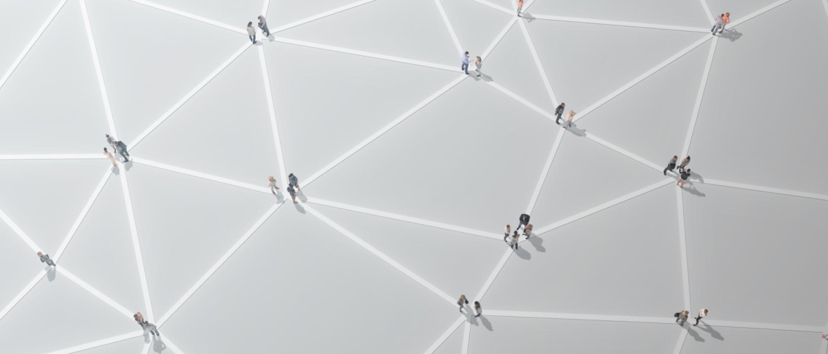 People walking across a geometric, network‑like patterned surface