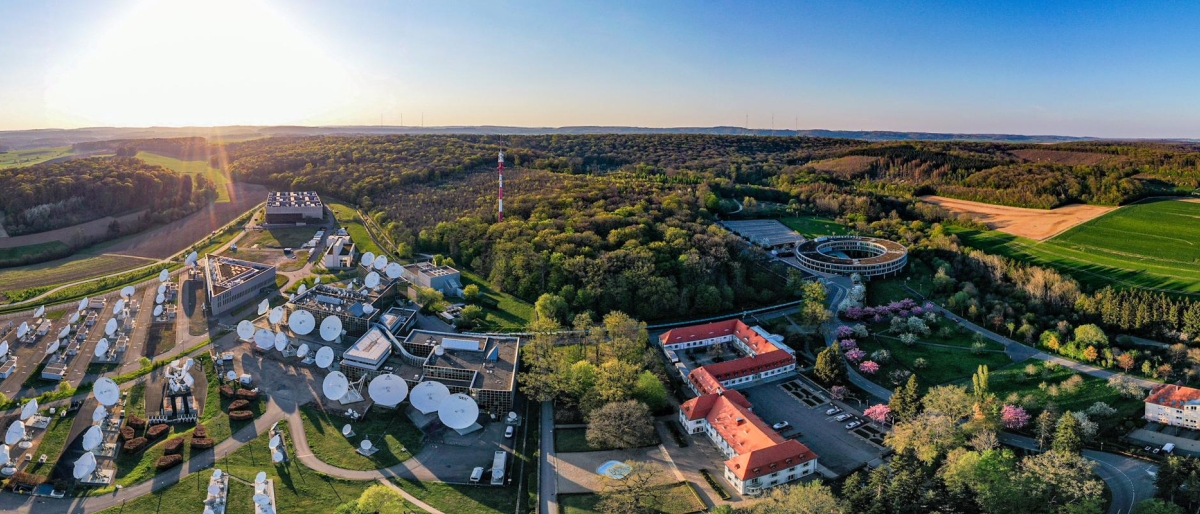Image of Aerial view of SES Betzdorf site with satellite dishes and forest surrounding it.