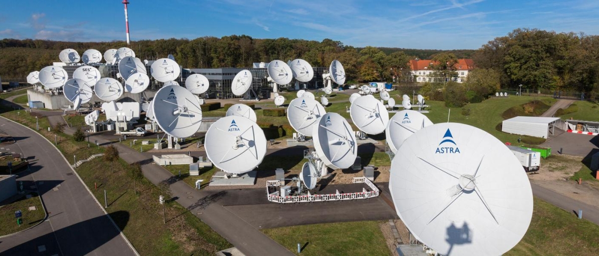 Image of large Astra antenna dishes in a field.