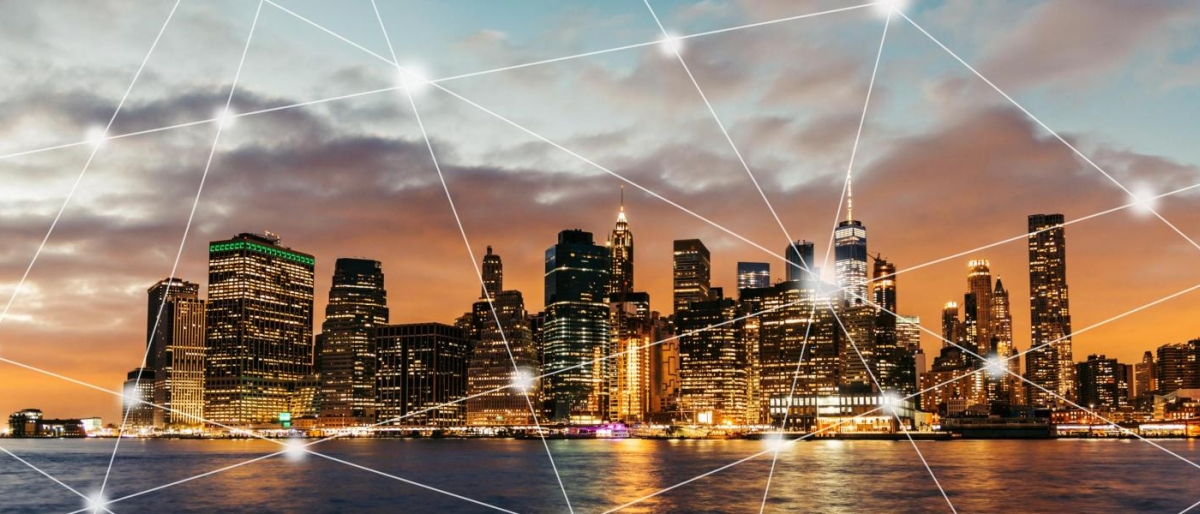 City skyline with glowing network lines connecting across the image.