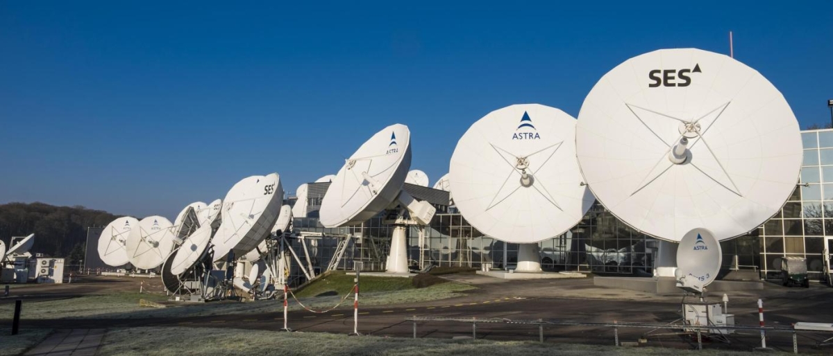 Image of SES and Astra satellite dishes outside a facility.