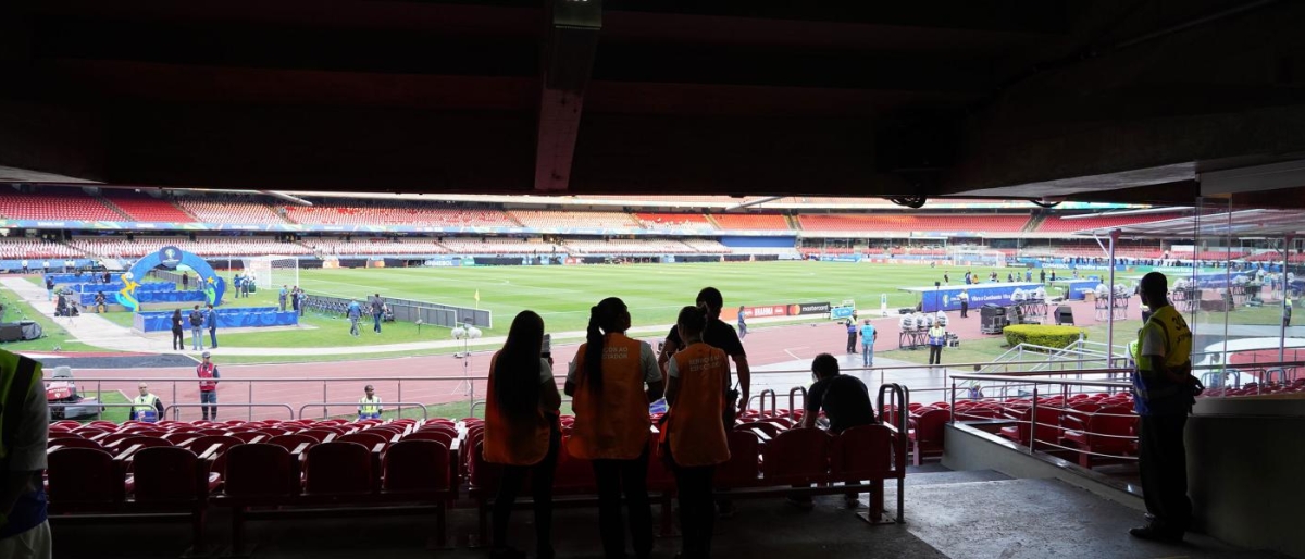 Image of stadium staff looking toward the field during an event setup.