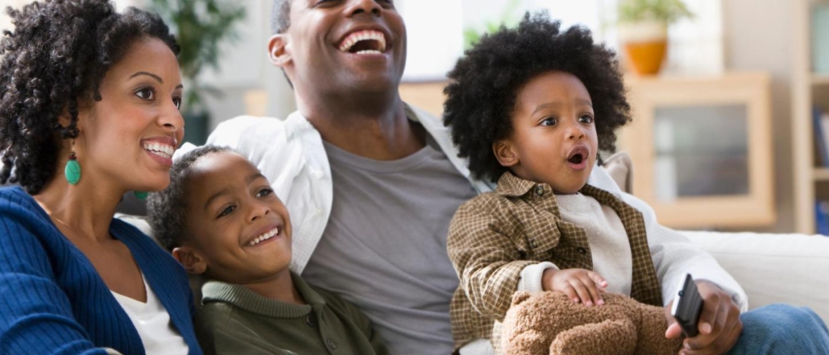 Image of a family sitting together on a couch.