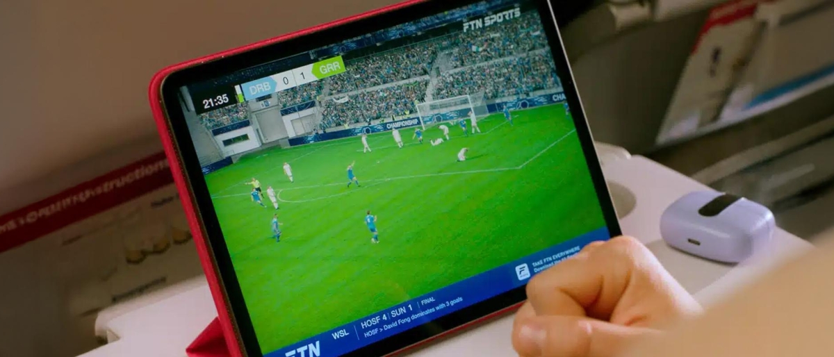 passenger watching sports on a tablet