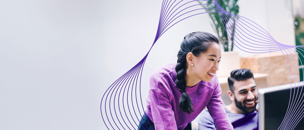 coworkers looking at monitor