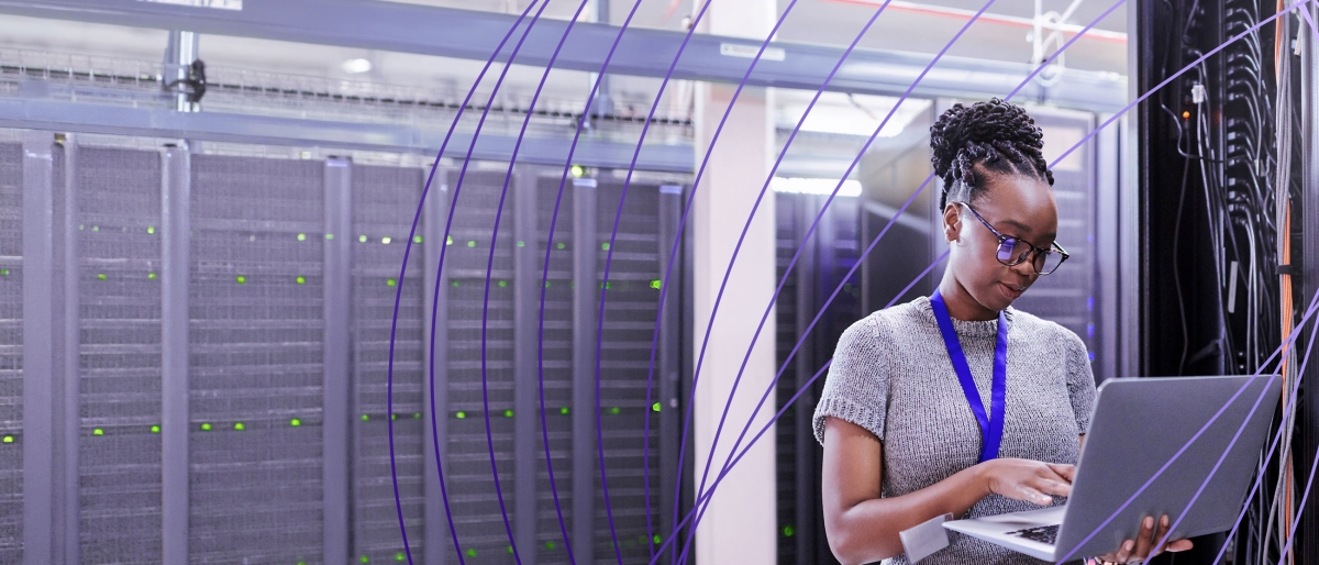 worker on laptop in server room