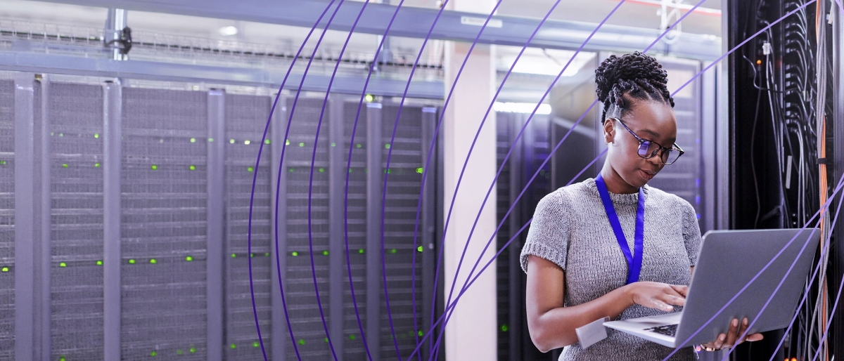 worker on laptop in server room
