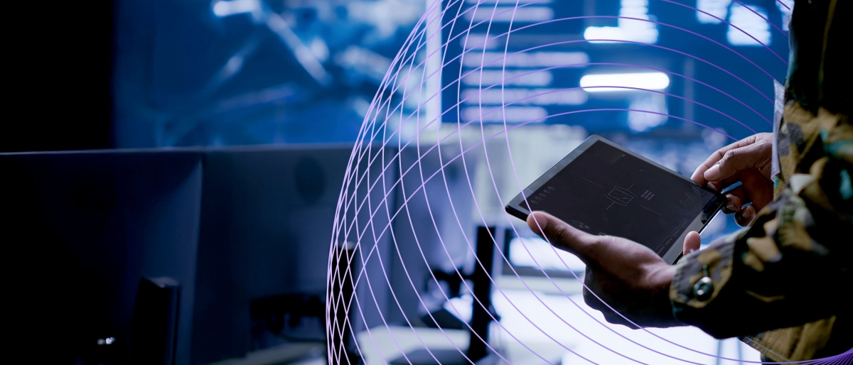 military person with tablet in control room